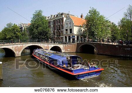 Tour boat on canal, Amsterdam. Holland View Large Photo Image Stock Photograph - Tour boat on canal, Amsterdam. Holland. Fotosearch