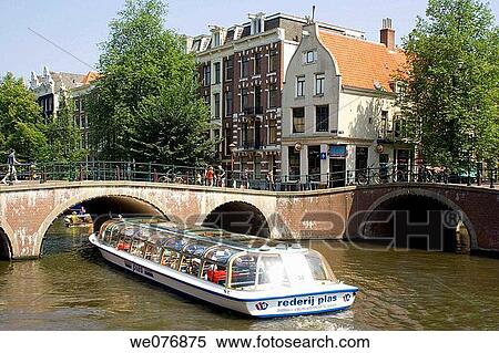 Tour boat on canal, Amsterdam. Holland View Large Photo Image Stock Photography - Tour boat on canal, Amsterdam. Holland. Fotosearch