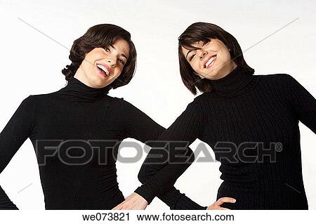 Stock Image - Twin sisters at play. Fotosearch