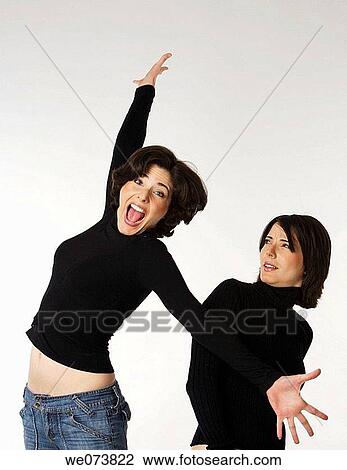 Twin sisters at play View Large Photo Image Stock Image - Twin sisters at play. Fotosearch