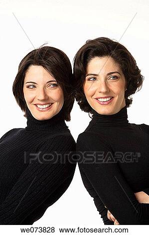 Twin sisters leaning on each other View Large Photo Image Stock Photo - Twin sisters leaning on each other. Fotosearch