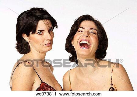 Twin sisters looking at the camera: one smiles while the other one looks sad View Large Photo Image Stock Image - Twin sisters looking at the camera: one smiles while the other one looks sad. Fotosearch