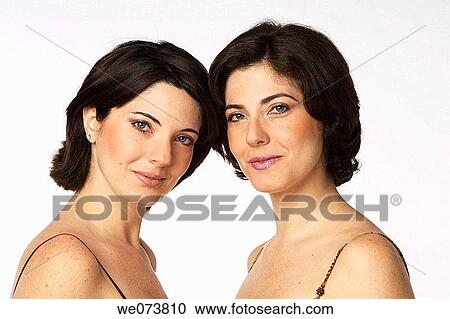 Twin sisters looking at the camera View Large Photo Image Stock Image - Twin sisters looking at the camera. Fotosearch