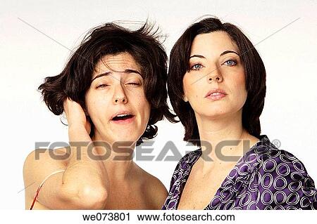 Twin sisters: one ready to go to work, the other one just woke up View Large Photo Image Stock Image - Twin sisters: one ready to go to work, the other one just woke up. Fotosearch