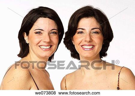 Twin sisters smiling at the camera View Large Photo Image Stock Photo - Twin sisters smiling at the camera. Fotosearch