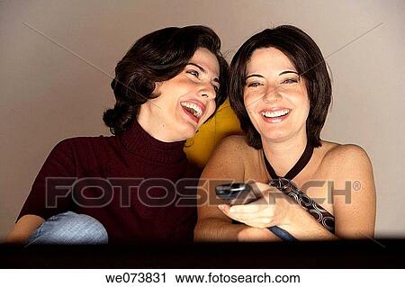 Twin sisters watching TV View Large Photo Image Stock Image - Twin sisters watching TV. Fotosearch