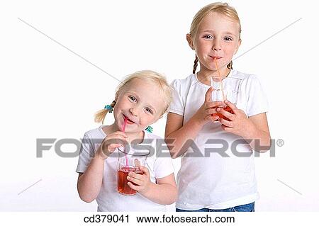 Two blond girls drinking lemonade with a straw View Large Photo Image Stock Image - Two blond girls drinking lemonade with a straw. Fotosearch