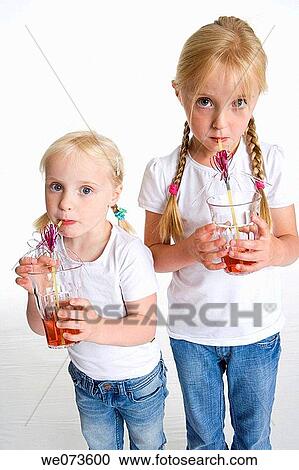 Two blond girls drinking lemonade with a straw View Large Photo Image Stock Image - Two blond girls drinking lemonade with a straw. Fotosearch