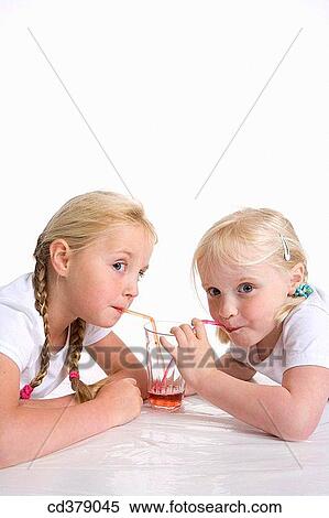 Two blond girls drinking lemonade with a straw View Large Photo Image Stock Photography - Two blond girls drinking lemonade with a straw. Fotosearch