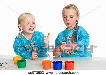 Stock Image - Two blond girls fingerpainting. Fotosearch