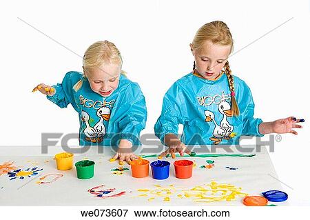 Two blond girls fingerpainting View Large Photo Image Stock Photo - Two blond girls fingerpainting. Fotosearch