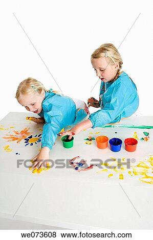 Two blond girls fingerpainting View Large Photo Image Stock Photo - Two blond girls fingerpainting. Fotosearch