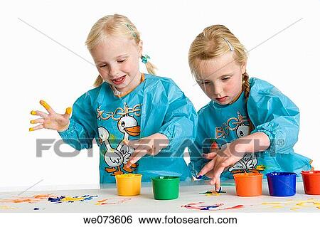 Stock Photograph - Two blond girls fingerpainting. Fotosearch