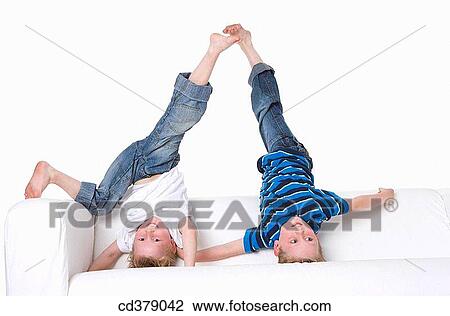 Stock Image - Two boys climbing on a bench. Fotosearch