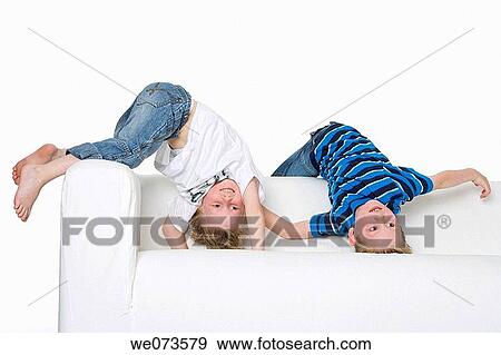 Two boys climbing on a bench View Large Photo Image Stock Photo - Two boys climbing on a bench. Fotosearch