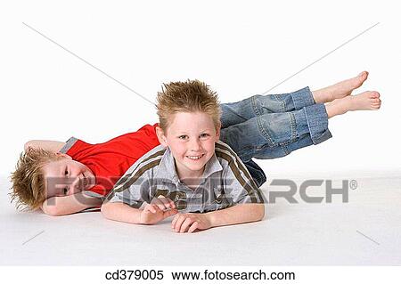 Two boys on the floor View Large Photo Image Stock Photography - Two boys on the floor. Fotosearch