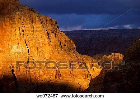 Warm late afternoon sunshine lights a spot on the wall of the Grand Canyon in Arizona, USA. View Large Photo Image Stock Photo - Warm late afternoon sunshine lights a spot on the wall of the Grand Canyon in Arizona, USA.. Fotosearch