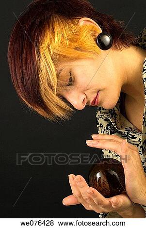 Woman holding amber ball View Large Photo Image Stock Photo - Woman holding amber ball. Fotosearch
