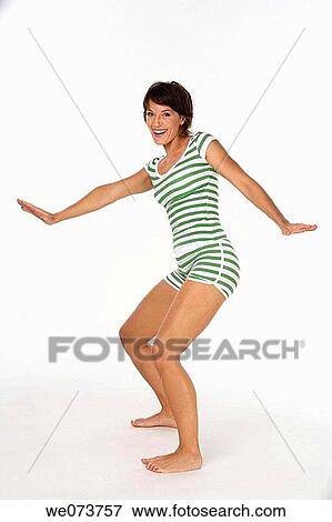 Woman in her 20s pretends to surf with a retro swimsuit in a studio setting View Large Photo Image Stock Photo - Woman in her 20s pretends to surf with a retro swimsuit in a studio setting. Fotosearch