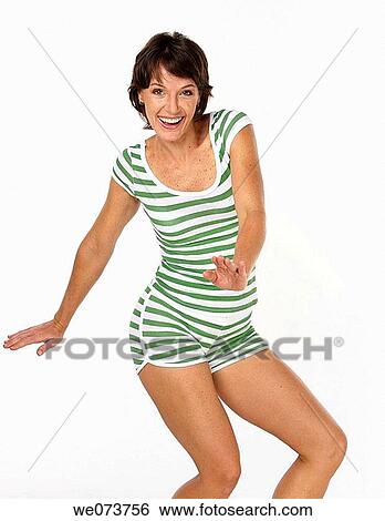 Woman in her 20s pretends to surf with a retro swimsuit in a studio setting View Large Photo Image Stock Photograph - Woman in her 20s pretends to surf with a retro swimsuit in a studio setting. Fotosearch