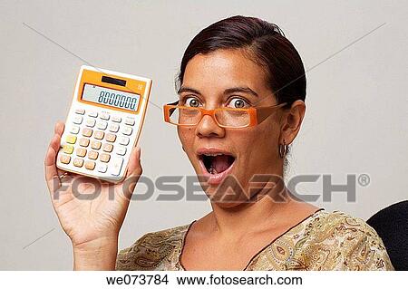 Woman in her 30s with retro sunglasses shows an 8 million figure on her calculator View Large Photo Image Picture - Woman in her 30s with retro sunglasses shows an 8 million figure on her calculator. Fotosearch
