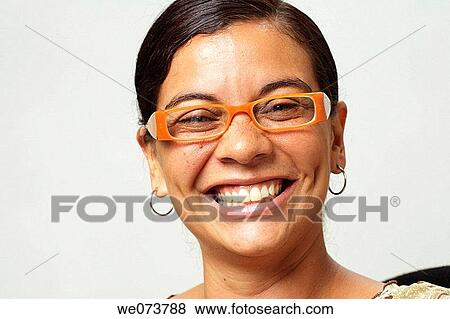 Woman in her 30s with retro sunglasses smiles at the camera View Large Photo Image Stock Photo - Woman in her 30s with retro sunglasses smiles at the camera. Fotosearch