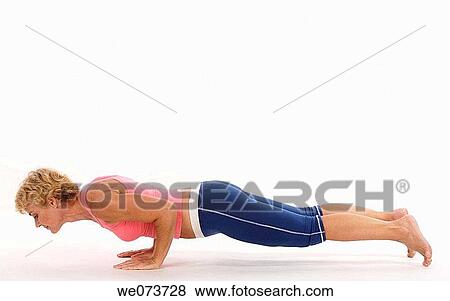 Woman in her 60s does a push up in a studio setting View Large Photo Image Stock Photo - Woman in her 60s does a push up in a studio setting. Fotosearch