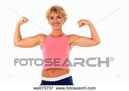 Woman in her 60s shows her muscles in a studio setting View Large Photo Image Stock Photo - Woman in her 60s shows her muscles in a studio setting. Fotosearch