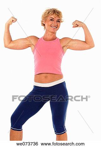 Woman in her 60s shows her muscles in a studio setting View Large Photo Image Stock Photograph - Woman in her 60s shows her muscles in a studio setting. Fotosearch