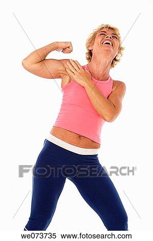 Woman in her 60s shows her muscles in a studio setting View Large Photo Image Stock Photography - Woman in her 60s shows her muscles in a studio setting. Fotosearch