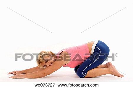 Woman in her 60s stretches in a studio setting View Large Photo Image Stock Photo - Woman in her 60s stretches in a studio setting. Fotosearch