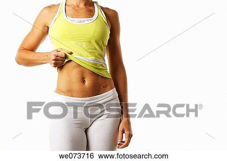 Woman in her late 20s shows her flat stomach View Large Photo Image Stock Photograph - Woman in her late 20s shows her flat stomach. Fotosearch