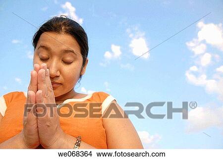 Picture - Woman in prayer. Fotosearch