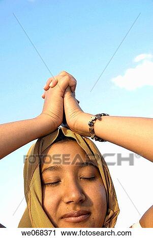 Woman praying wearing a? hijab? (a veil - from the Arabic word? hajaba? - to cover) View Large Photo Image Stock Image - Woman praying wearing a? hijab? (a veil - from the Arabic word? hajaba? - to cover). Fotosearch