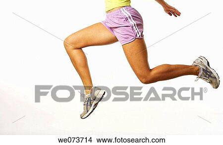 Woman running in a studio setting View Large Photo Image Picture - Woman running in a studio setting. Fotosearch