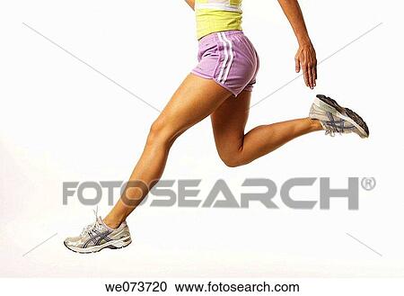 Woman running in a studio setting View Large Photo Image Stock Image - Woman running in a studio setting. Fotosearch