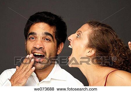 Woman screaming at a man while he doesn? t seem to care or listen View Large Photo Image Stock Photo - Woman screaming at a man while he doesn? t seem to care or listen. Fotosearch