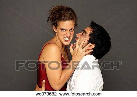 Woman stops man from kissing her in studio View Large Photo Image Stock Image - Woman stops man from kissing her in studio. Fotosearch