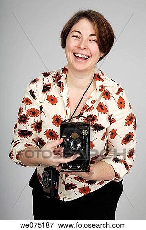 Stock Photo - woman with antique camera. Fotosearch