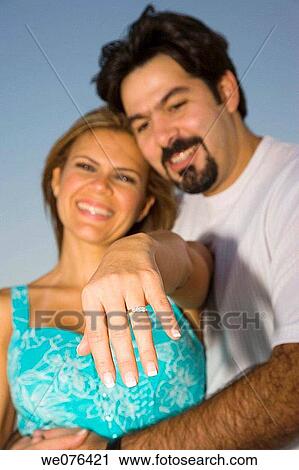 Stock Image - Woman with man showing engagement ring, Deerfield Beach, Florida, USA. Fotosearch