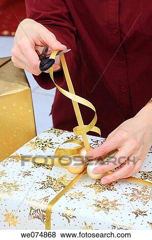 Woman wrapping up Christmas present, Christmas gift View Large Photo Image Stock Photo - Woman wrapping up Christmas present, Christmas gift. Fotosearch