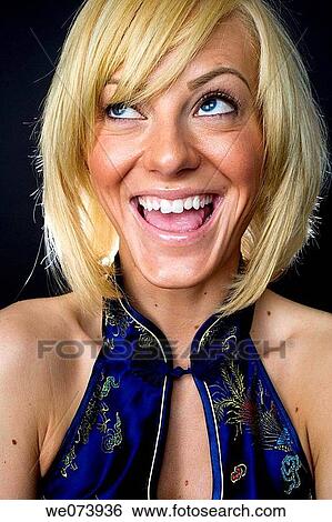 Young (20? s) blond caucasian woman makes a happy face in studio made head and shoulders portrait. View Large Photo Image Stock Photograph - Young (20? s) blond caucasian woman makes a happy face in studio made head and shoulders portrait.. Fotosearch