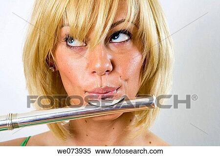 Young (20? s) blond caucasian woman accesses her right brain while playing the flute in studio portrait View Large Photo Image Stock Photography - Young (20? s) blond caucasian woman accesses her right brain while playing the flute in studio portrait. Fotosearch