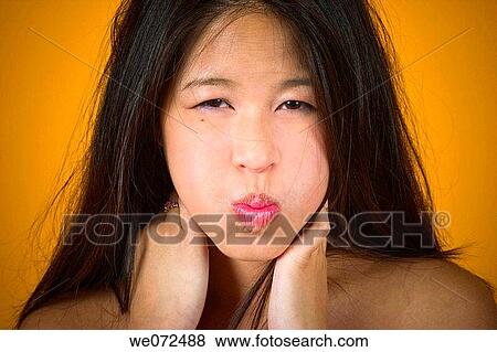 Young Asian woman puckering her lips. View Large Photo Image Stock Photo - Young Asian woman puckering her lips.. Fotosearch