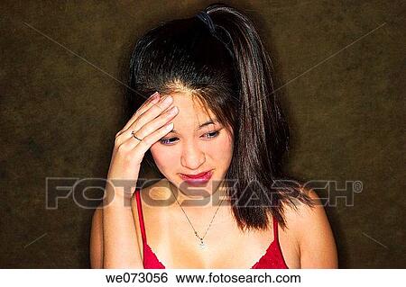 Young Asian woman with her hand on her head. View Large Photo Image Stock Photograph - Young Asian woman with her hand on her head.. Fotosearch