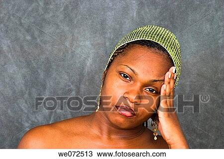 Young black woman with her hand on her face View Large Photo Image Stock Image - Young black woman with her hand on her face. Fotosearch