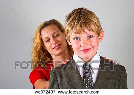 Young blond boy, who is wearing a suit, and his young blond mother posing together. View Large Photo Image Stock Photo - Young blond boy, who is wearing a suit, and his young blond mother posing together.. Fotosearch