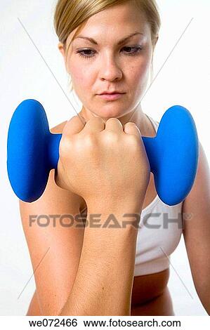Young blond woman focuses on lifting barbell during workout. View Large Photo Image Stock Photograph - Young blond woman focuses on lifting barbell during workout.. Fotosearch