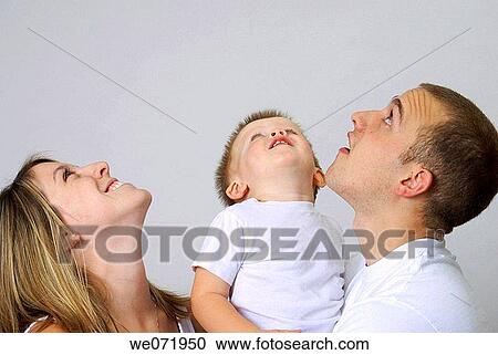 Young family looking up at the same time. View Large Photo Image Stock Image - Young family looking up at the same time.. Fotosearch