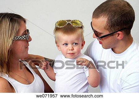 Young family with sunglasses for eye protection. View Large Photo Image Stock Photo - Young family with sunglasses for eye protection.. Fotosearch